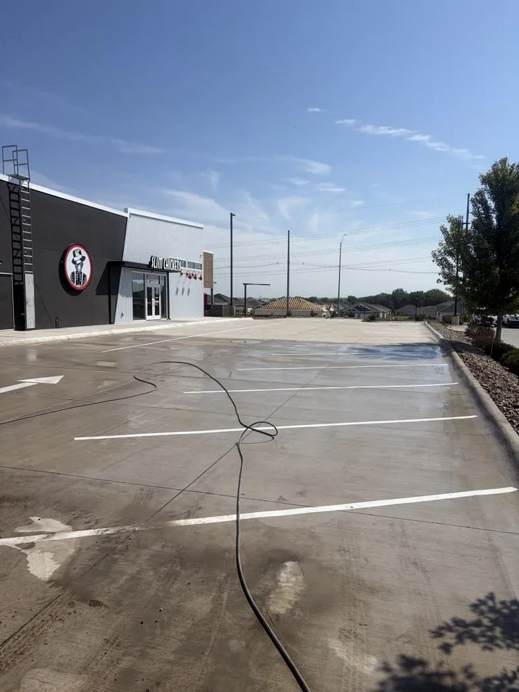A wider view of a commercial parking lot after pressure washing