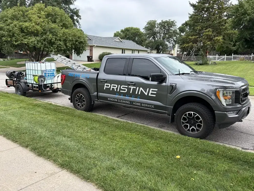 The Pristine Panes truck and pressure washing trailer at a job