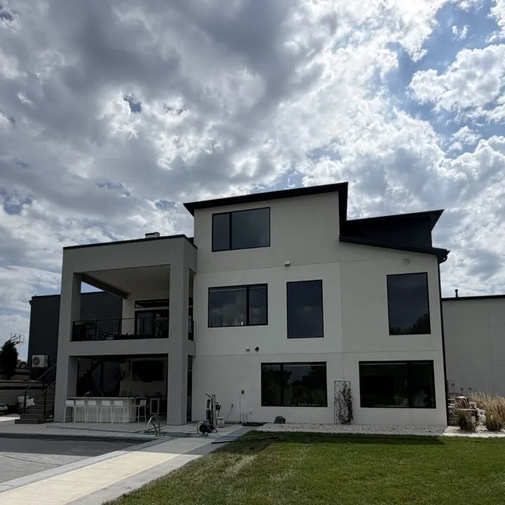 A modern white home with large clean windows