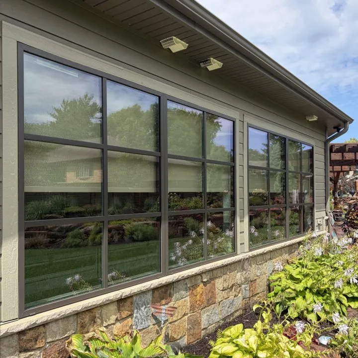 A wall of clean windows along the side of a home