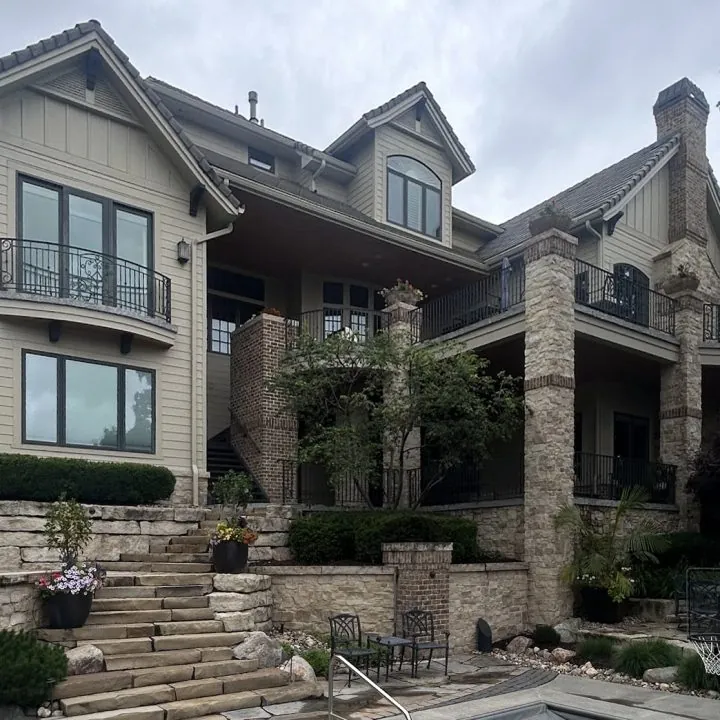 A hillside home with stone steps and clean windows