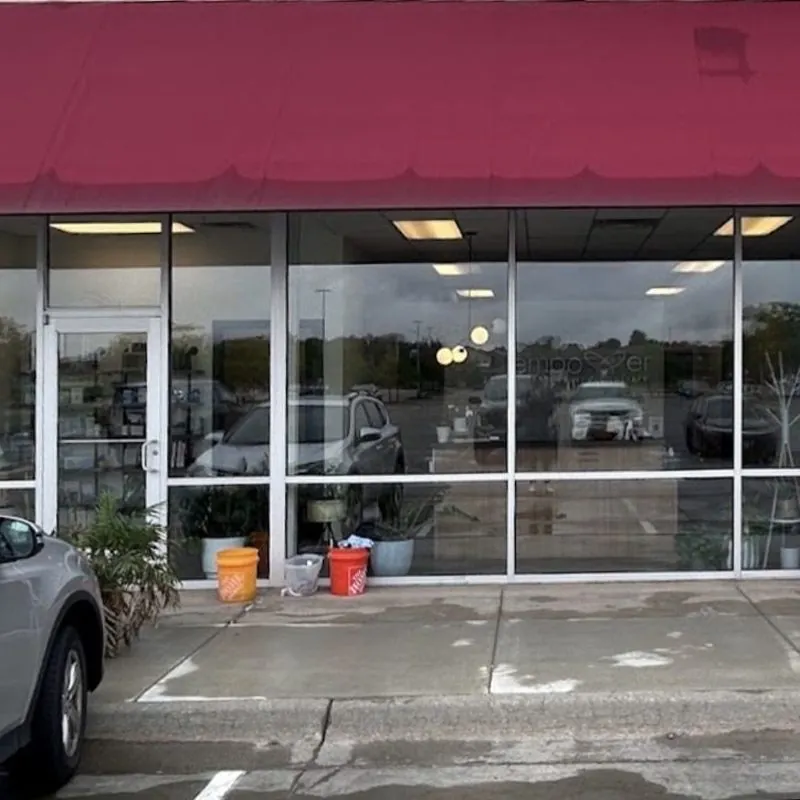 A storefront with clean glass and a freshly washed sidewalk